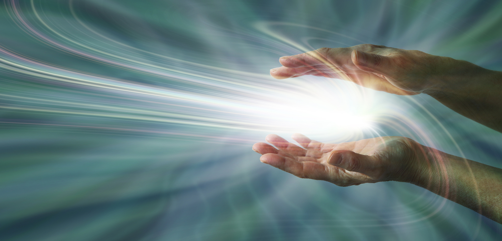 Parallel female hands with a swirling light burst between on a blue-gray energy field background