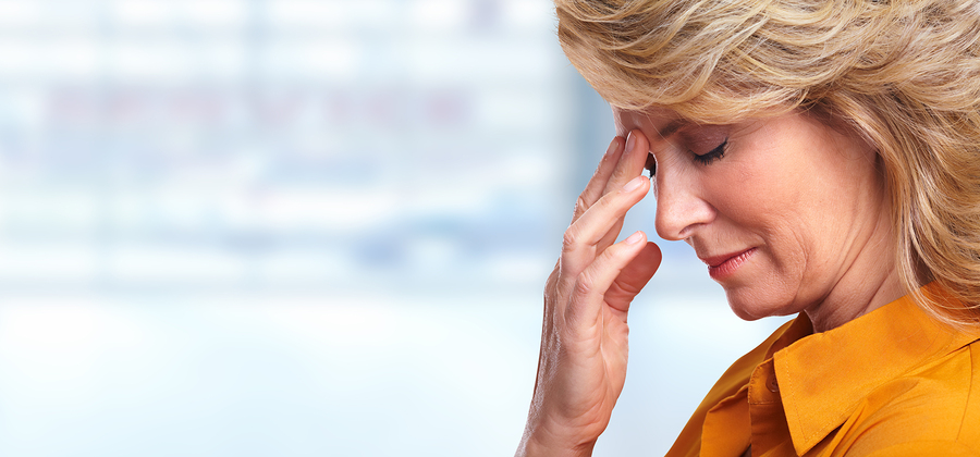 Woman having migraine headache; visual metaphor for stress and depression.
